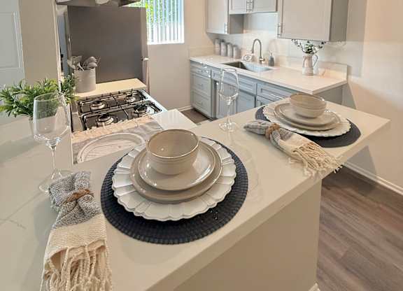 A kitchen with a white countertop and a black and white placemat.
