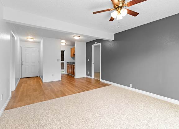 A room with a ceiling fan and a carpeted floor.at East Wind, Oregon, 97030