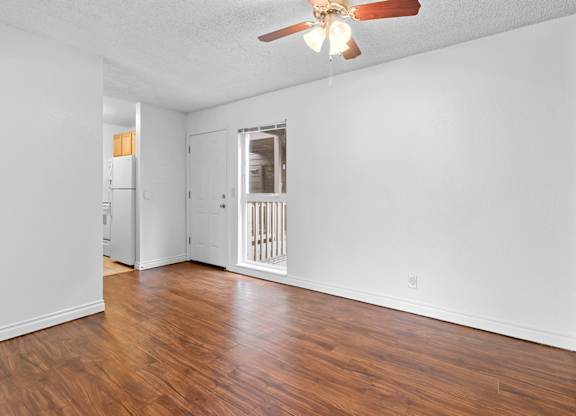 A room with a ceiling fan and wooden floors.at East Wind, Gresham, OR 97030