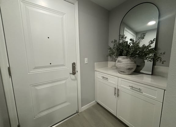 a large white door with a mirror in a bathroom