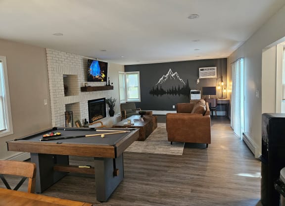 Clubhouse with a pool table and a tv