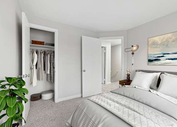 A bedroom with a large bed and a painting on the wall.