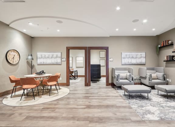 a room with couches and chairs and a table