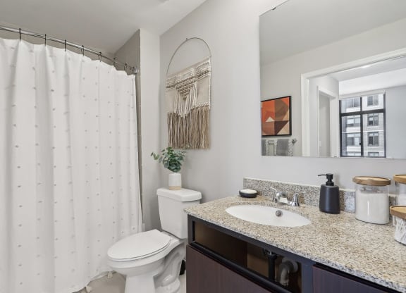 a bathroom with a shower and a sink and a toilet