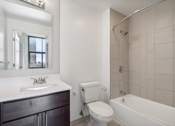 a bathroom with a toilet sink and tub and a shower