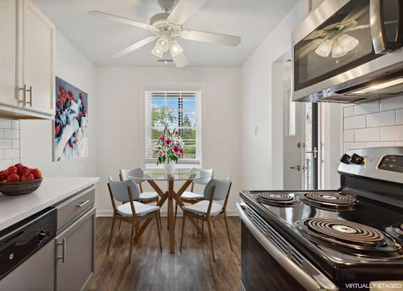 A modern kitchen with a dining table set for four.