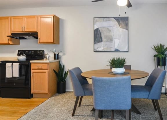 a kitchen and dining room with a table and chairs at ReNew Aurora, Illinois