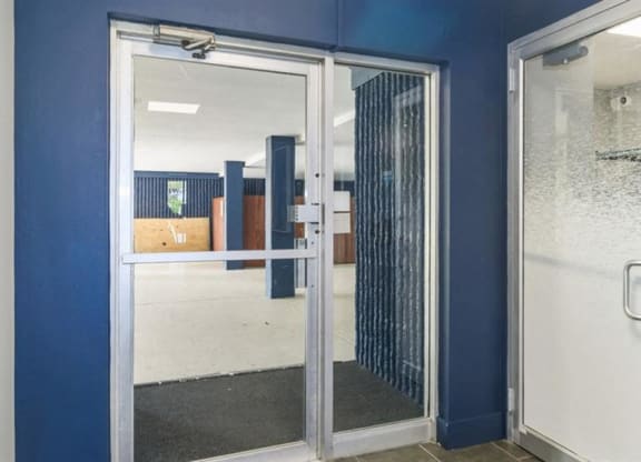 a blue room with a glass door and a blue wall at ReNew Aurora, Aurora, IL, 60506