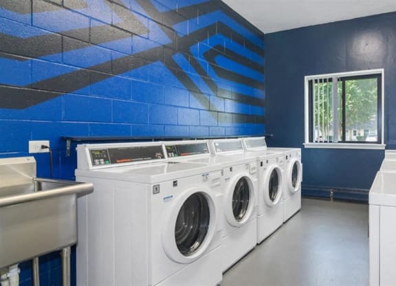 a laundry room with white washing machines and sinks at ReNew Aurora, Aurora, IL, 60506