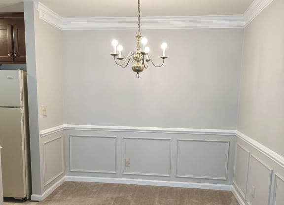 a dining room with wainscotting and a chandelier at Woodgate, Charlottesville, 22901