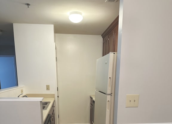 a kitchen with white cabinets and a white refrigerator at Woodgate, Virginia