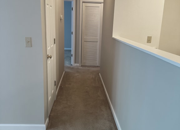 a bedroom with a medium sized bed and a mirror on the wall at Woodgate, Charlottesville, Virginia