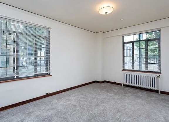 Carpeted floor, a window with blinds, and a radiator at The Lafayette, Portland, OR, Oregon , 97205