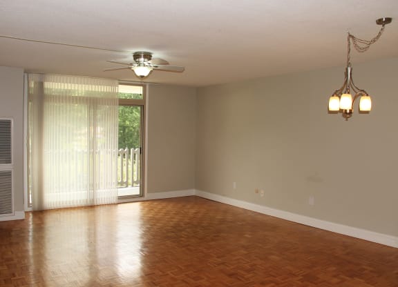 an empty living room with wood floors and a ceiling fan at Renew Worcester, Worcester, MA, 01602