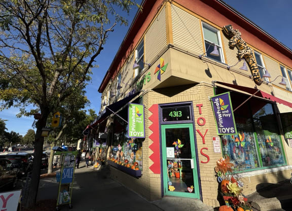 the outside of a store with a cheetah statue on the side of it