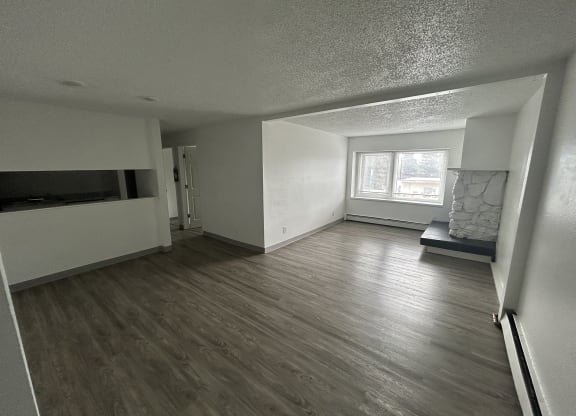 an empty living room with wood flooring and a window at Kings Court, Anchorage, AK ?