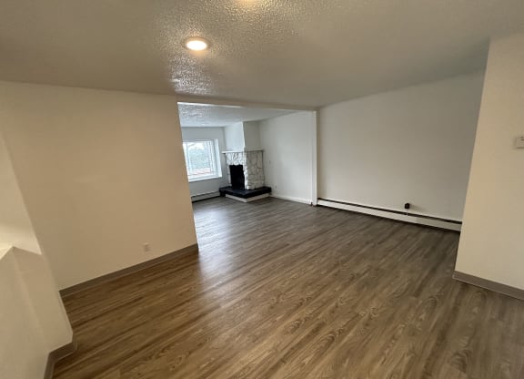 a room with 6 faces on the walls and a wooden floor at Kings Court, Anchorage Alaska ?