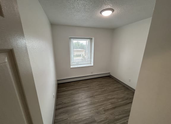 an empty bedroom with wood flooring and a window at Kings Court, Alaska, 99501?