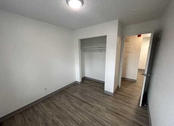 an empty room with a hallway and a closet at Kings Court, Anchorage Alaska ?