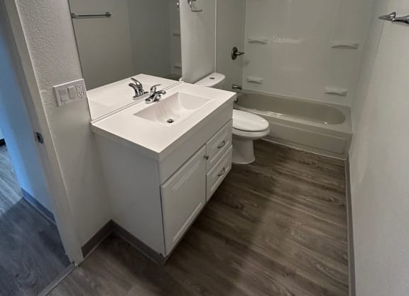 a bathroom with a sink and a toilet and a mirror at Kings Court, Anchorage, AK 99501 ?