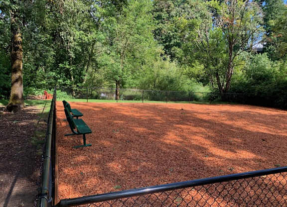 Clean dog park with a bench with fence at Miramonte Lodge, Milwaukie, 97222