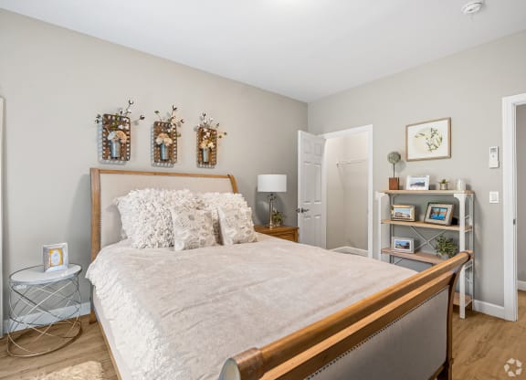 a bedroom with a large bed and a mirror at Lofts at 335, Stratford, Connecticut
