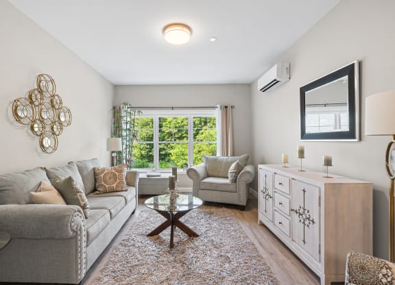 a living room with a couch and two chairs at Lofts at 335, Stratford, CT