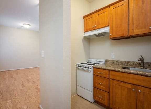 apartment interior with hardwood floors and a view of the kitchen at Maurice Dear Apartments, Oregon