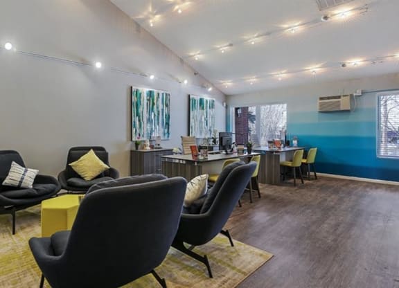 Clubhouse interior with white and blue wall colors and couch at Twelve 501 Apartment Homes, Burnsville, Minnesota
