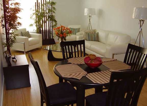 A dining room with a table set for four.