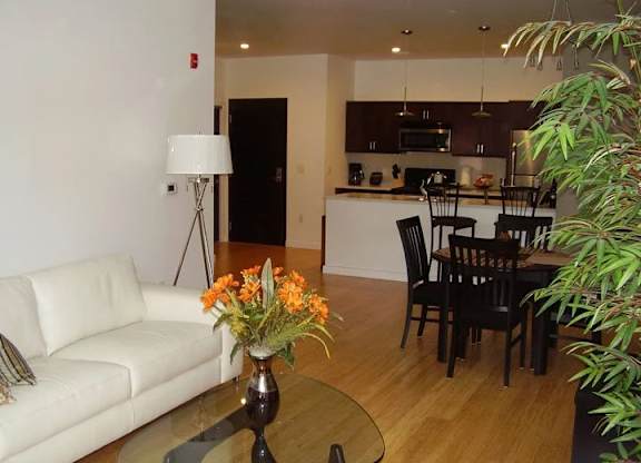 A white couch sits in a living room with a coffee table in front of it.