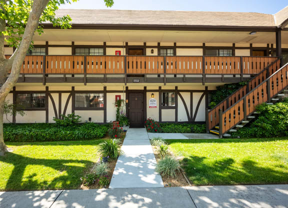 the front of a building with a sidewalk and grass at Oak Park Apartments, Solvang, CA