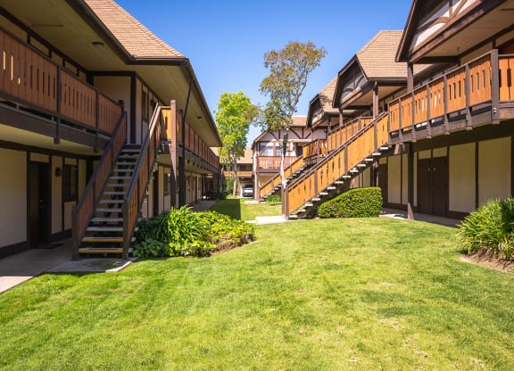 apartment building with stairs and a grass yard at Oak Park Apartments, Solvang, California