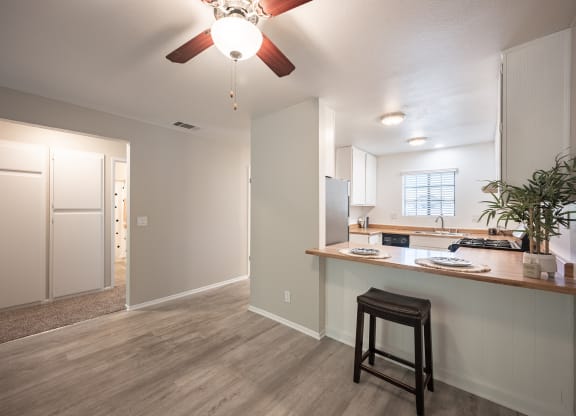 kitchen and living room with a ceiling fan at Oak Park Apartments, Solvang, 93463
