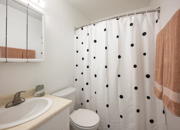 a bathroom with a shower and a sink and a toilet at Oak Park Apartments, California
