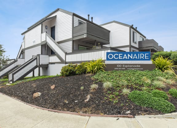 Monument sign of Oceanaire and apartment building  at OceanAire Apartment Homes, Pacifica, California
