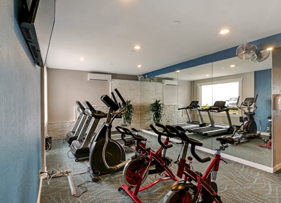 Fitness center with treadmills, ellipticals and bikes  at OceanAire Apartment Homes, Pacifica, CA
