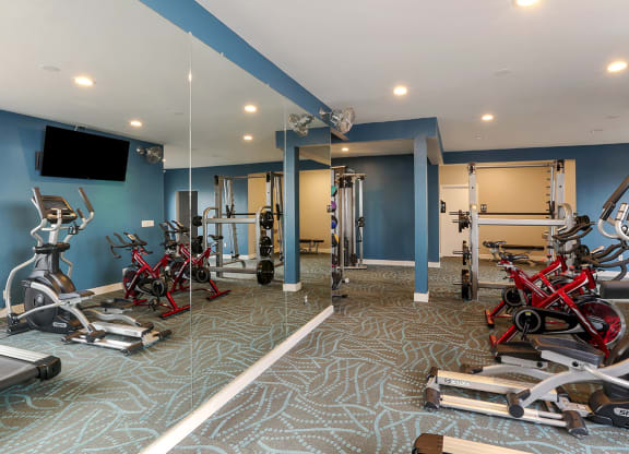 Fitness center with free weights and exercise equipment  at OceanAire Apartment Homes, Pacifica, CA, 94044