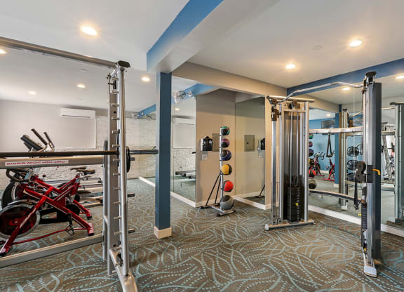 Fitness center with free weights and exercise equipment  at OceanAire Apartment Homes, California, 94044