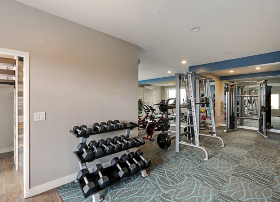 Fitness center with weights  at OceanAire Apartment Homes, Pacifica