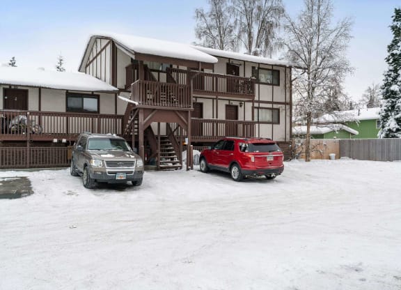 a house with snow on the roof and a red truck parked in front of it  at ReNew End Street, Alaska, 99577