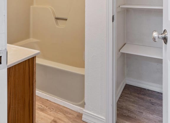a bedroom with a medium sized closet and a bathtub  at ReNew End Street, Alaska