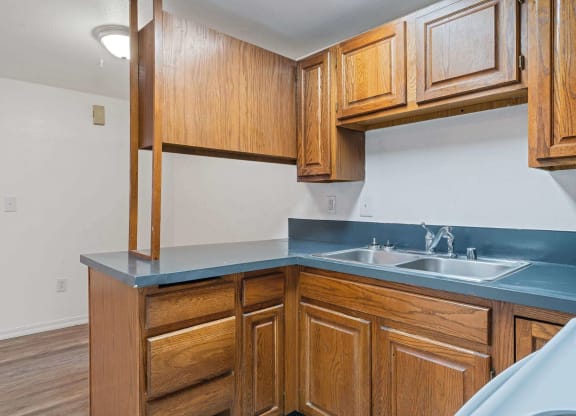 a kitchen with wooden cabinets and a blue counter top  at ReNew End Street, Alaska, 99577