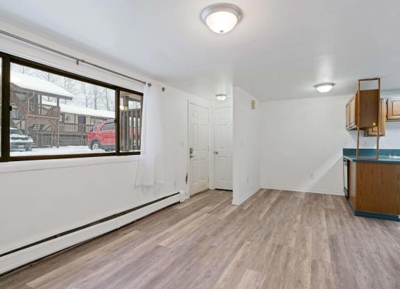 a living room with hardwood floors and a large window  at ReNew End Street, Alaska, 99577