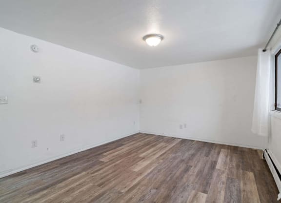 bedroom with hardwood floors and white walls  at ReNew End Street, Alaska, 99577
