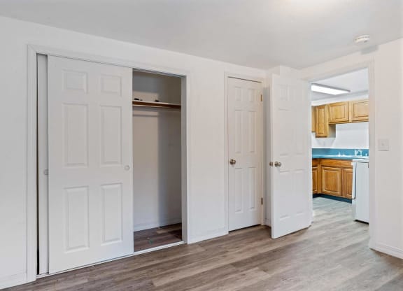 a bedroom with two doors and a kitchen in the background  at ReNew End Street, Alaska, 99577