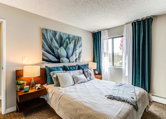 our apartments offer a bedroom with a king sized bed  at ReNew at Neill Lake, Eden Prairie, Minnesota