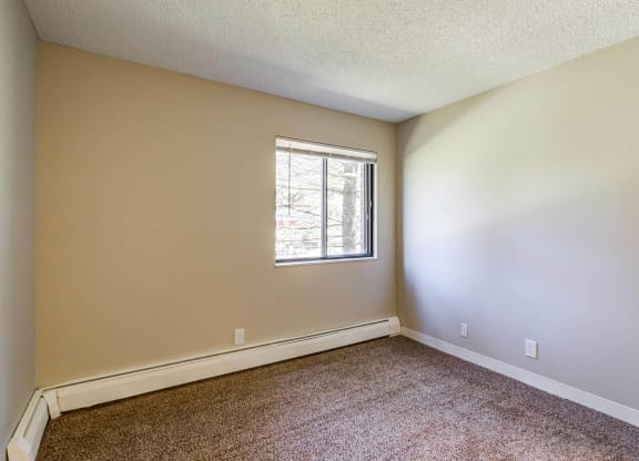 a bedroom with carpet and a window  at ReNew at Neill Lake, Eden Prairie, MN, 55344