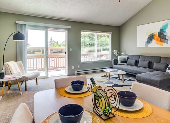 a living room with a table and chairs with a couch in the background at The Bluffs at Mountain Park, Oregon, 97035