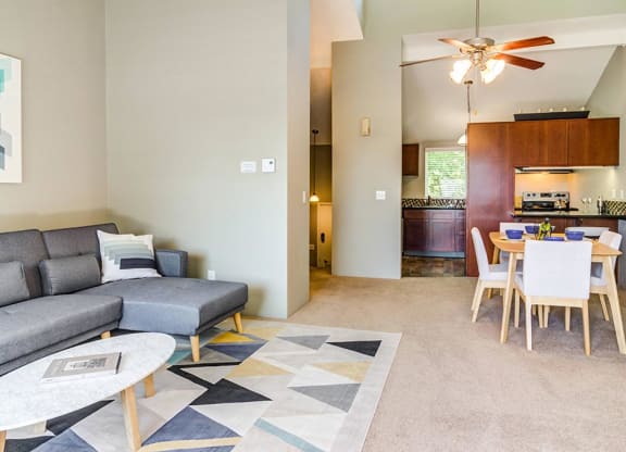 a living room with a couch a table and a ceiling fan at The Bluffs at Mountain Park, Oregon